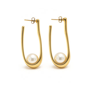 Gold hoop earrings with pearl centers on a white background