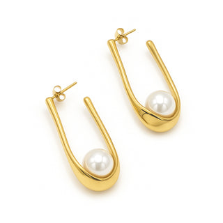Gold hoop earrings with pearl centers on a white background
